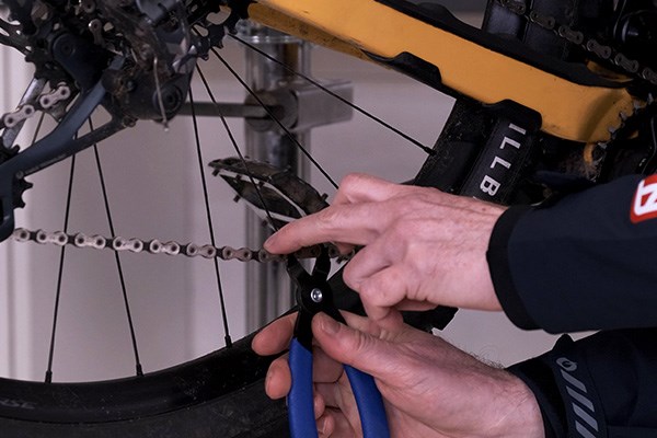 park tools quick link pliers being used to remove a sram quick link